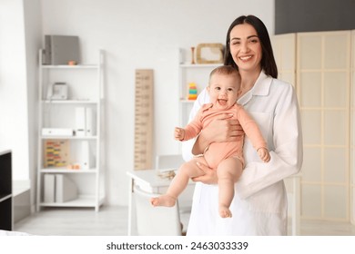 Portrait of female pediatrician with little baby in clinic - Powered by Shutterstock