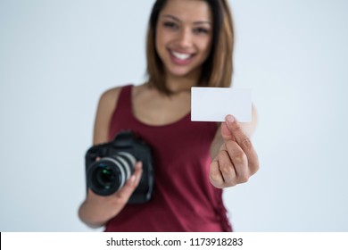 Portrait Of Female Photographer Showing Visiting Card In Studio