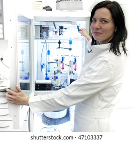 Portrait Of A Female Researcher Carrying Out Research Experiments In A Lab - Researcher Taking A Substance From A Freezer