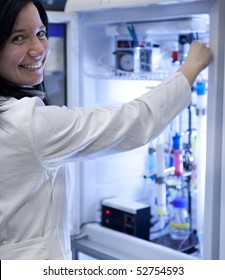 Portrait Of A Female Researcher Carrying Out Research Experiments In A Lab - Researcher Taking A Substance From A Freezer