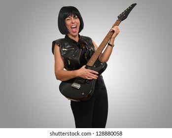 Portrait Of Female Rockstar Against A Grey Background