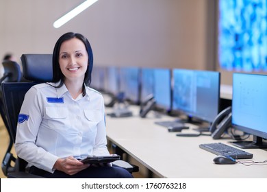 portrait of female security operator while working in a data system control room offices Technical Operator Working at  workstation with multiple displays, security guard working on multiple monitors