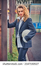 Portrait Of Female Soccer Coach With Ball At The Stadium