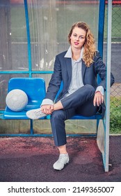 Portrait Of Female Soccer Coach With Ball At The Stadium