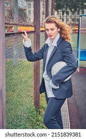 Portrait Of Female Soccer Coach With Ball At The Stadium