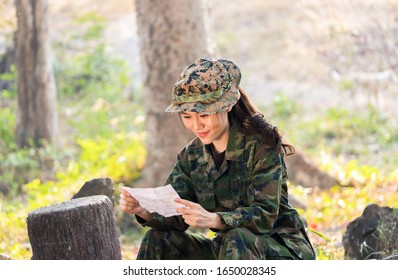 Portrait Of A Female Soldier Sitting Happily Reading A Letter