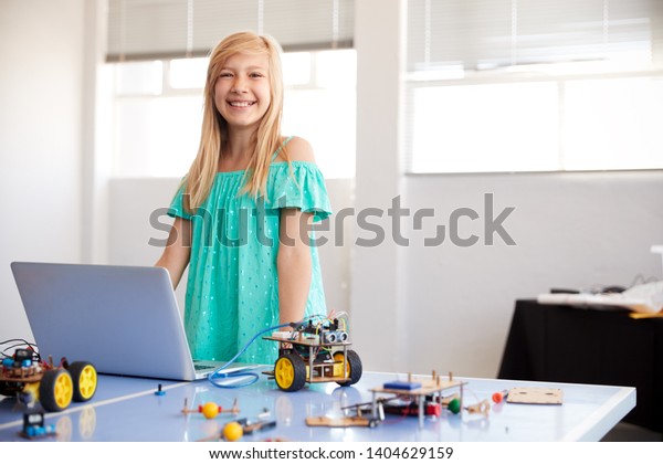 Portrait Of Female Student Building\
And Programing Robot Vehicle In School Computer Coding\
Class