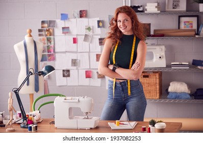 Portrait Of Female Student Or Business Owner With Tape Measure Working In Fashion Standing By Desk - Powered by Shutterstock