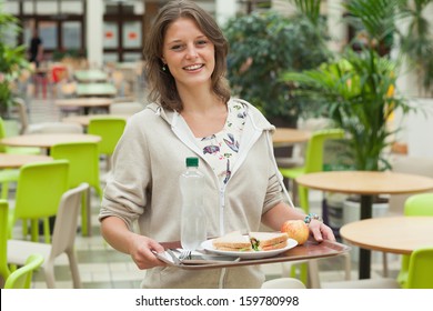 Portrait Of A Female Student Carrying Food Tray In The Cafeteria