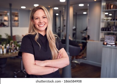 Portrait Of Female Stylist Or Business Owner In Hairdressing Salon