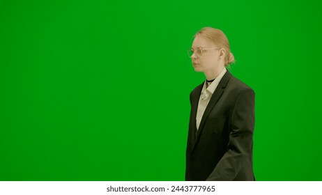 Portrait of female in suit on chroma key green screen. Blonde business woman in formal outfit walking with confident focused face expression. - Powered by Shutterstock