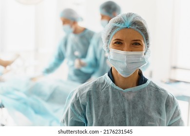 Portrait of female surgeon standing in operating room, ready to work on patient - Powered by Shutterstock