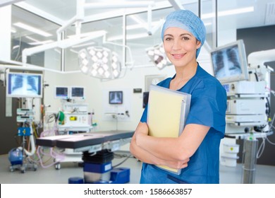 Portrait Of Female Surgeon Wearing Scrubs In Empty Operating Theater