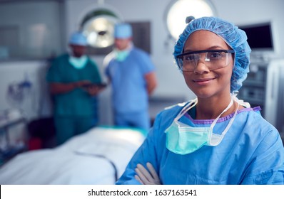Portrait Of Female Surgeon Wearing Scrubs And Protective Glasses In Hospital Operating Theater - Shutterstock ID 1637163541