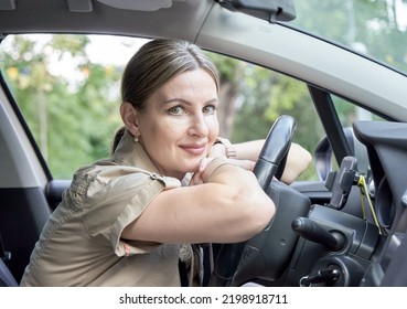 Portrait Of Female Taxi Driver Driving Her Car.