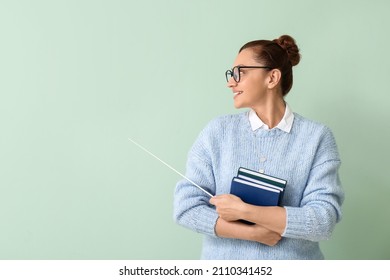 Portrait Of Female Teacher With Books And Pointer On Color Background