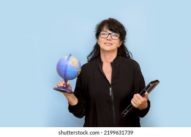 portrait of female teacher with globe and laptop and inspired expression. - Shutterstock ID 2199631739