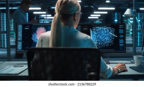 Portrait of Female Technical Operator Works with Display Showing Neural Network In the System Control Dark Room. Caucasian IT Technician Works on Artificial Intelligence. Big Data Scientific Research.