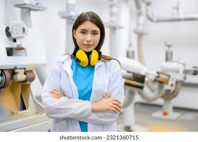 Portrait of female technician looking at camera with arm crossed - Powered by Shutterstock