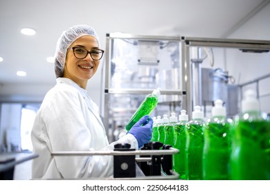 Portrait of female technologist controlling production of cleaning supplies or sanitation chemicals for cleaning industry. - Powered by Shutterstock