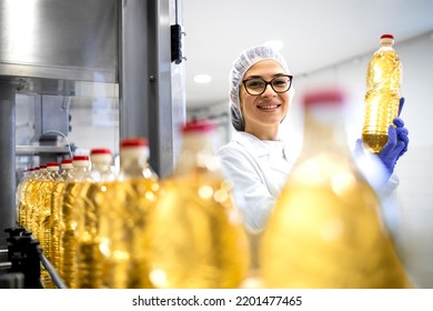 Portrait of female technologist inside food production factory and controlling quality of refined vegetable oil products. - Powered by Shutterstock