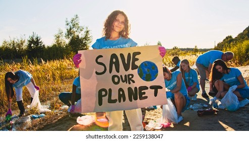 Portrait of female teenager activist holding Save Our Planet poster. Girl volunteer protesting against garbage, rubbish pollution. Strike, protest concept. Nature, environment preservation. - Powered by Shutterstock