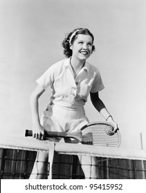Portrait of female tennis player at the net