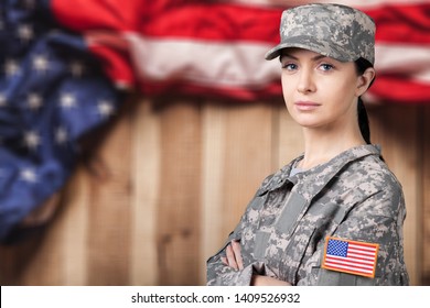 Portrait Of Female US Army Soldier On Flag Background