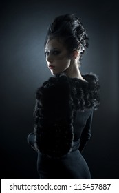 Portrait of female vampire over dark background