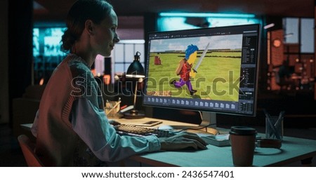 Portrait of Female Video Game Designer Working on a New 3D Level on Her Desktop Computer. Focused Woman Creating Metaverse and Design Video Game Character in Creative Office at Night