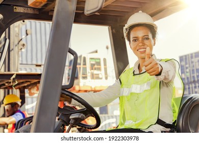 Portrait Female Worker Driving A Forklift Showing His Thumb Up : African American Female Foreman, Forklift Driver, Import And Export Cargo, Port Transportation