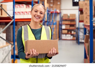 Portrait Of Female Worker Holding Box Inside Warehouse - Powered by Shutterstock