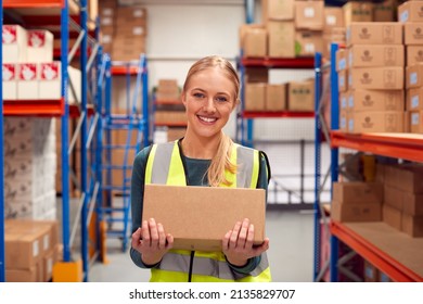 Portrait Of Female Worker Holding Box Inside Warehouse - Powered by Shutterstock