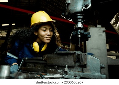 Portrait of a female worker, technician, professional engineer, hat, standing working on machinery in a factory, warehouse concept, on a factory production line. Heavy industry production process - Powered by Shutterstock