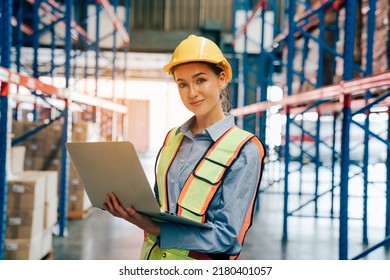 Portrait of female worker using laptop working in warehouse, Industrial and industrial workers concept. - Powered by Shutterstock