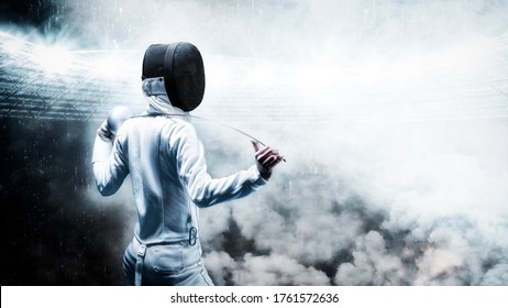 Portrait of a fencer against the backdrop of a sports arena. Smoke and sparks, mystical background. The concept of fencing. Back view. Mixed media - Powered by Shutterstock