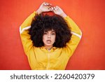Portrait, fierce and black woman with attitude, power and empowerment with afro on studio background. Face, African American female creative and lady with confidence, casual outfit and motivation