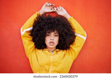 Portrait, fierce and black woman with attitude, power and empowerment with afro on studio background. Face, African American female creative and lady with confidence, casual outfit and motivation