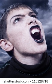 Portrait Of Fierce Vampire With Sharp Long Teeth On Stormy Night.