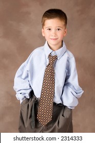 Portrait Of A Filipino Boy Dressed Up In Adult Business Clothes