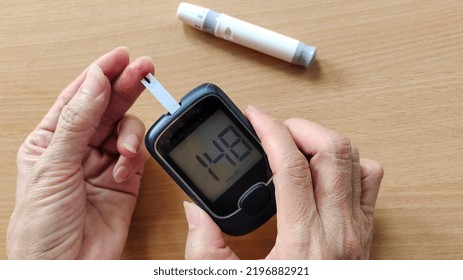 Portrait The Fingertip Check Of Diabetes, Showing High Blood Sugar On Monitor, Hyperglycemia Patient Woman Take Proactive Control, Concept Health Care. 