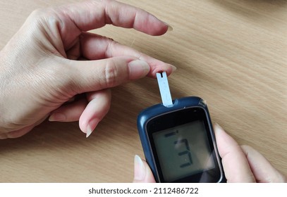 Portrait Fingertip Check, Showing Blood Sugar On Monitor, Patient Take Proactive Control, Concept Health Care.