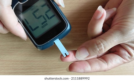 Portrait Fingertip Check, Showing High Blood Sugar On Monitor, Patient Take Proactive Control, Concept Health Care.