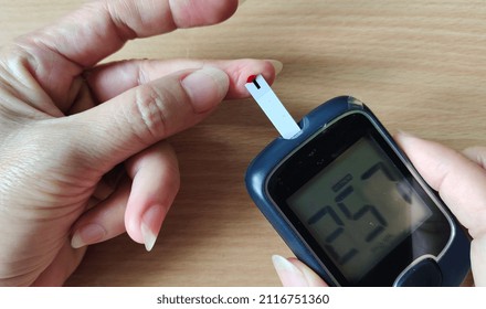 Portrait Fingertip Check, Showing High Blood Sugar On Monitor, Patient Take Proactive Control, Concept Health Care.