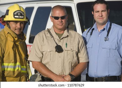 Portrait Of A Firefighter, Traffic Cop And EMT Doctor Standing Together