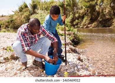 Portrait of fishermen - African man and his little son posing with bucket of fish catch - Shutterstock ID 1465469012