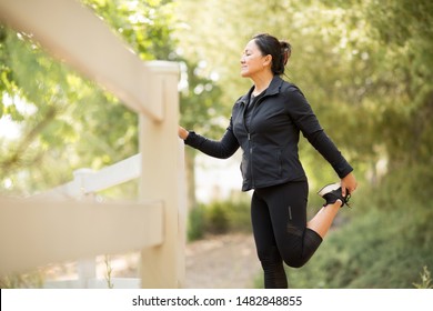 Portrait Of A Fit Asian Woman Exercising Outside.