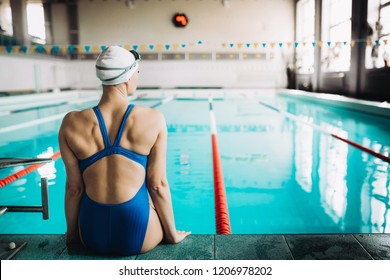 Portrait Of A Fit Female Swimmer By The Pool At Leisure Center