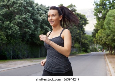 Portrait Of A Fit Young Woman Running Outside