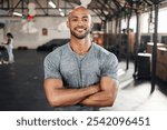 Portrait, fitness and happy man with arms crossed for workout, body health and wellness in gym. Face, smile and confident bodybuilder, personal trainer and strong athlete with muscle in sports club